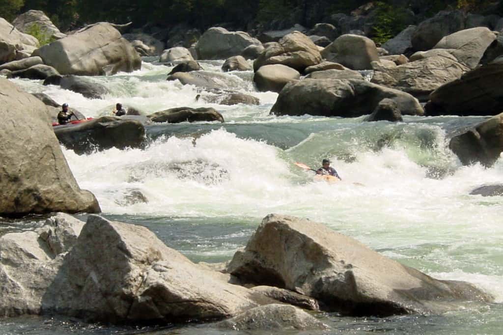 Kayakers running Blind Faith Rapid in the Miracle Mile of Cherry Creek