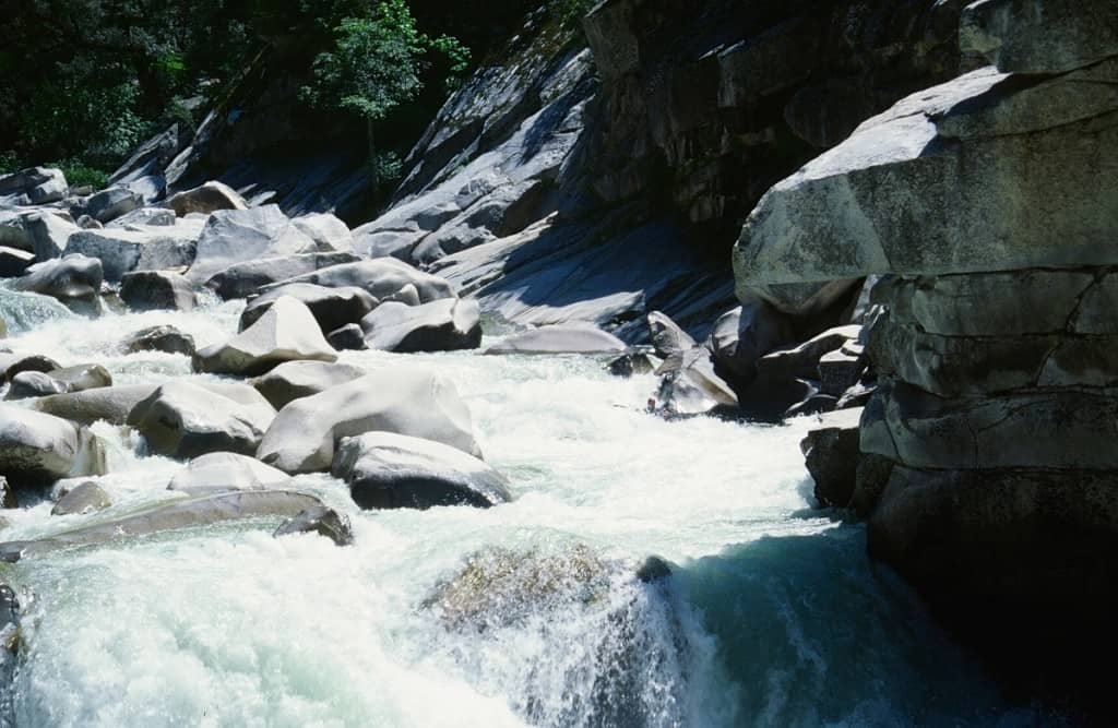 Kayaker running the bottom drops of Granite Dome Falls