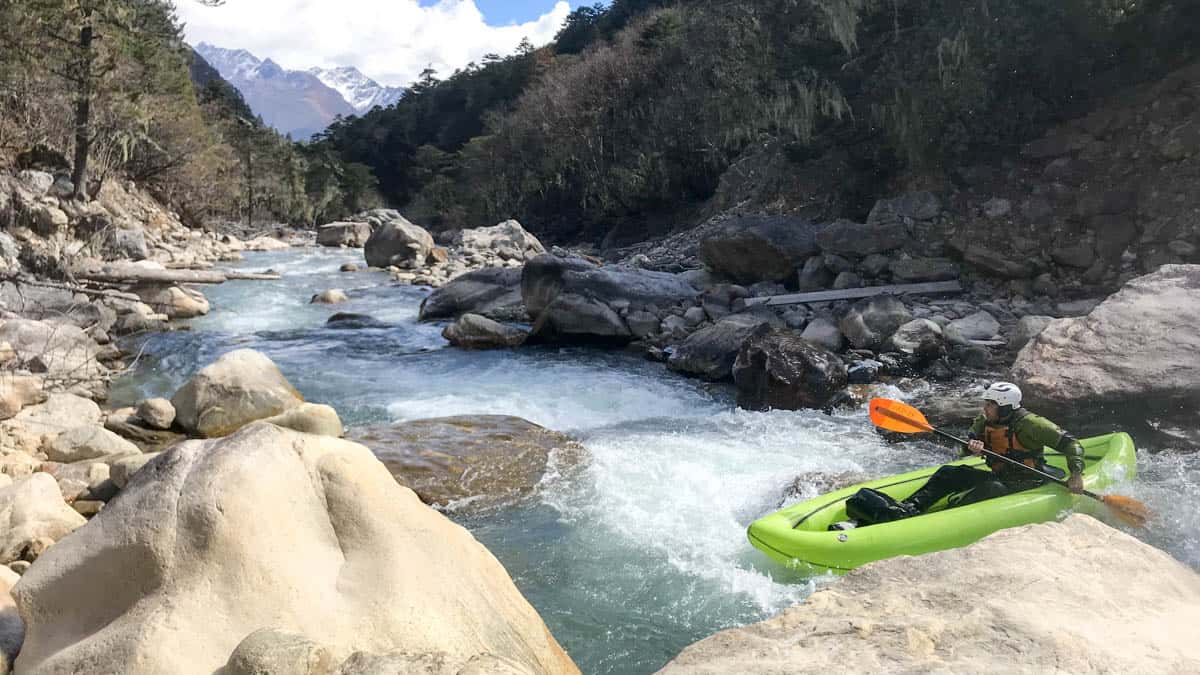 Inflatable kayaking a small, steep river in Bhutan
