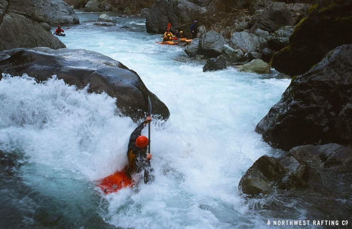 Kayaker going right of the rock in the left channel at Island Rapid