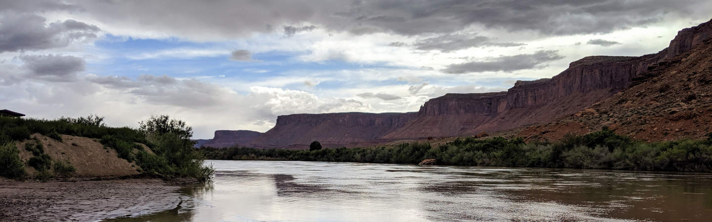 Red rock cliffs line the river on the Moab Daily.