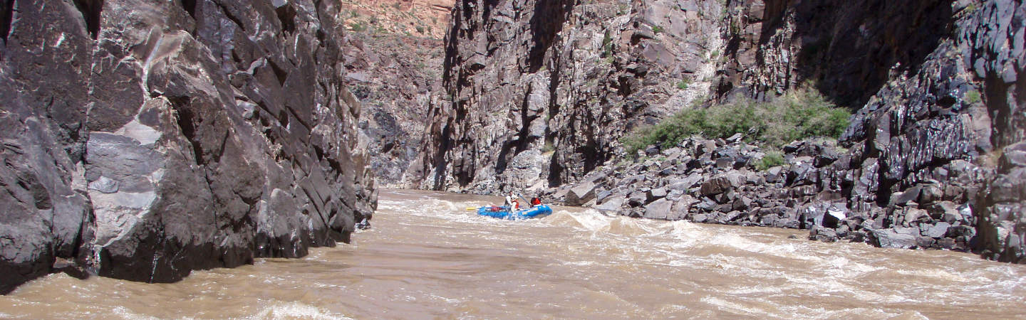 A group runs one of the many class II rapids in Westwater Canyon. Photo by MoabAdventurer.