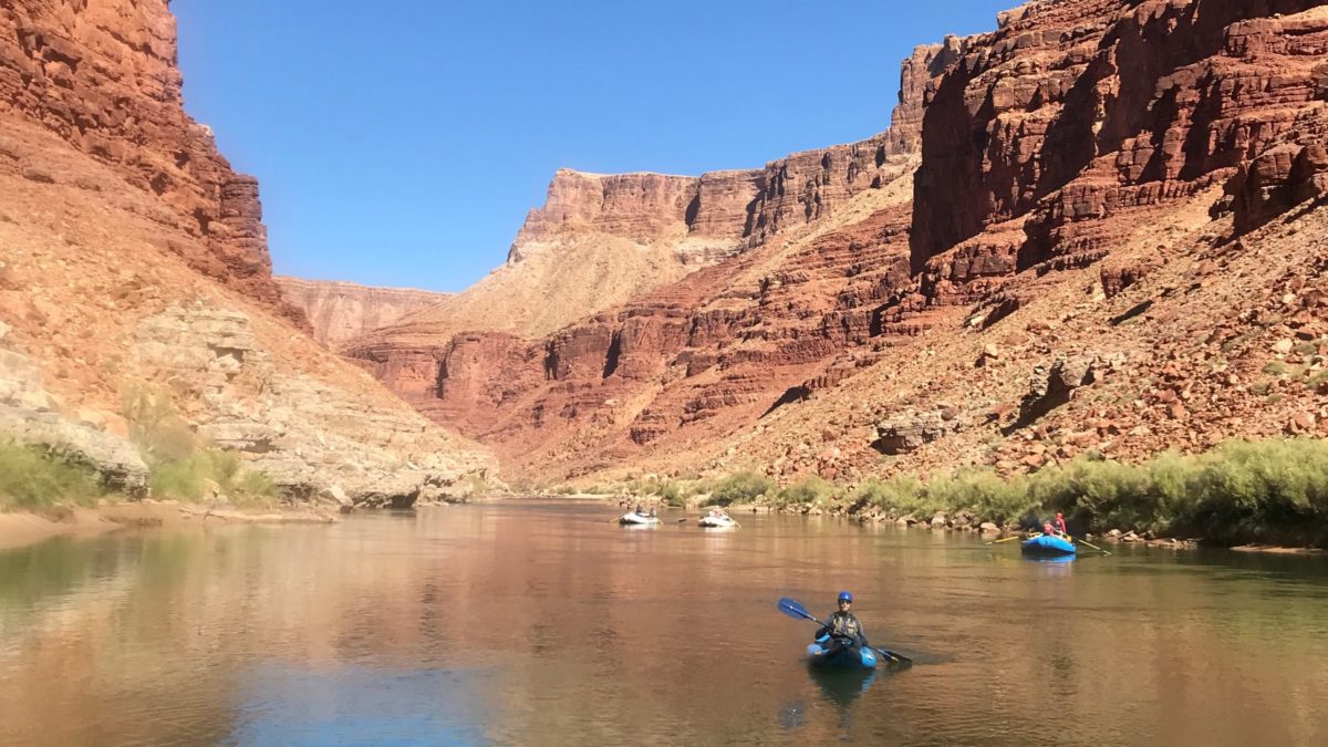 Inflatable kayaker paddling the flat water