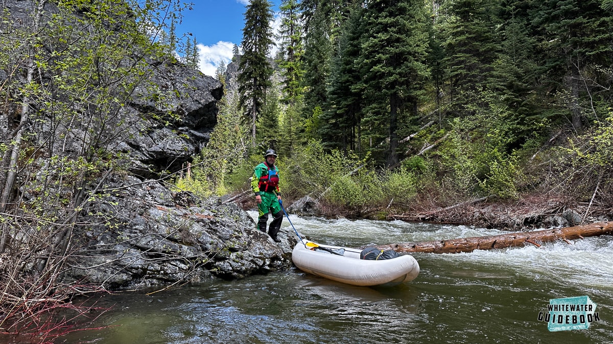 Lining around a river wide log found at the bottom of a rapid